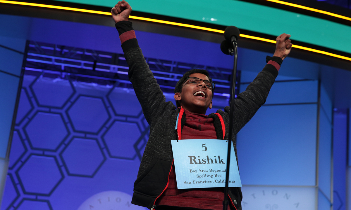 A news photo of Rishik Gandhasri celebrating winning the championship of the Scripps National Spelling Bee